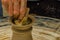 Closeup of the hands of the artist creating a clay pot, the trad