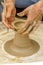 Closeup of the hands of the artist creating a clay pot, the trad