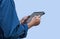 Closeup hands of Asian mechanic working on tablet isolated on blue background