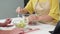 Closeup hands asian senior couple watching recipe with tablet making salad vegetable together in kitchen.