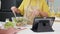 Closeup hands asian senior couple watching recipe with tablet making salad vegetable together in kitchen at home.