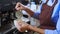 Closeup hands of barista preparing making coffee cappuccino or latte while pouring milk in coffee cup in cafe.