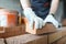 Closeup hands of bricklayer laying brick wall of house