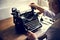 Closeup of hands changing paper on vintage typewriter