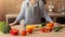 Closeup of hands of chef cook cutting vegetables on wooden table