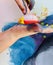 Closeup of hands of a child painting - colorful hands with paint and sponge