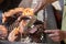 Closeup of hands cutting cooked delicious Argentinian barbeque beef steak meat with a knife