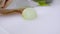 Closeup hands cutting white onion on a white cutting board.