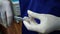 Closeup hands of dental technician wearing gloves working with plier at kid orthodontic appliance