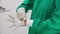 closeup hands doctor or surgeon wearing glove preparing surgery emergency in the operating room.