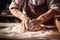 closeup of the hands of an elderly woman making dough on a wooden table