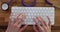 Closeup of hands of female doctor nurse working on computer keyboard