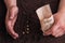 Closeup hands of gardener planting corn sugar seeds.