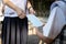 Closeup of hands of girl student hold surgical mask,sharing medical mask with kid girl at school,giving hygienic mask to prevent