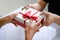 Closeup of hands giving gift box in Christmas day and new year festival to each other. Holiday and event. Surprising giftbox in