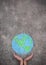 Closeup hands holding earth draw with chalk.