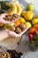 Closeup of hands holding walnuts, fruits in background