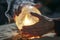 closeup of hands hovering over glowing crystal ball, incense smoke curling