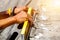 Closeup hands of laborer holding a building level working at construction site