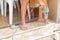 Closeup hands of laborer holding electric drill working drilling aluminum lumber at construction site