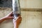 Closeup hands of laborer holding tools and galvanized pipe to repair at construction site