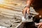 Closeup hands of laborer holding wood trowel working at construction site