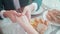 Closeup hands of man putting ring on finger of woman for marriage or engagement together with surprise at restaurant.