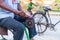 Closeup hands of a man sharpening a knife on a DIY makeshift sharpening machine on a bicycle frame