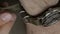 Closeup of the hands of men in khaki clothes, worn on the wrist of the diver`s watch on nylon strap.