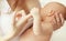 Closeup hands, mother feeding breast baby