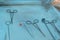 Closeup, the hands of a nurses hand, an assistant surgeon takes a surgical instrument from a sterile table. In a sterile operating