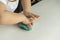 Closeup hands of a preschooler child knead turquoise mass for modeling