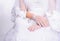 Closeup hands of sitting bride