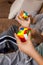 Closeup hands smart babies assembling Rubik\'s cube 3x3 enjoying early development game at home