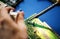 Closeup of hands soldering tin to electronics circuit board