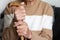 Closeup of the hands of a very elderly person in a beige sweater health concept