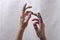 Closeup of hands, winding threads, thimbles against of white fabric.Concept of handicraft workers