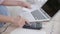 Closeup hands of woman calculating finance household with calculator on desk at home.