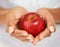 Closeup, hands and woman with a red apple, nutrition and healthy snack with diet plan. Person, home and girl with a