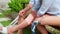 Closeup hands young asian couple disabled take care while woman applying bandage with man for rehabilitation and injury.