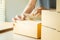 Closeup hands of young man packing boxes.