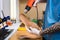 Closeup Hands of young man with tattoo in workshop dressed in blue uniform make individual orthopedic insoles. The instrument uses