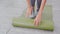 Closeup hands of young woman rolling with mat yoga on floor for preparation meditation and exercise for recreation.