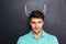 Closeup of handsome young man with drawn devil horns