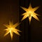 Closeup of hanging illuminated kringle moravian paper stars - Christmas concept