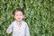 Closeup happy asian kid with admire motion on plant backdrop wedding textured background with copy space