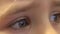 Closeup of Happy Baby Girl Eyes Looking TV, Reflections in Eyes. 4K UltraHD, UHD