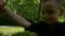 Closeup of happy child dancing and spinning with his mother while holding her hands