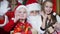 Closeup, happy children with gifts in hands waving together with Santa