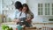 Closeup happy couple cooking together at home. Beautiful man and woman having fun. A young couple prepares a peanut